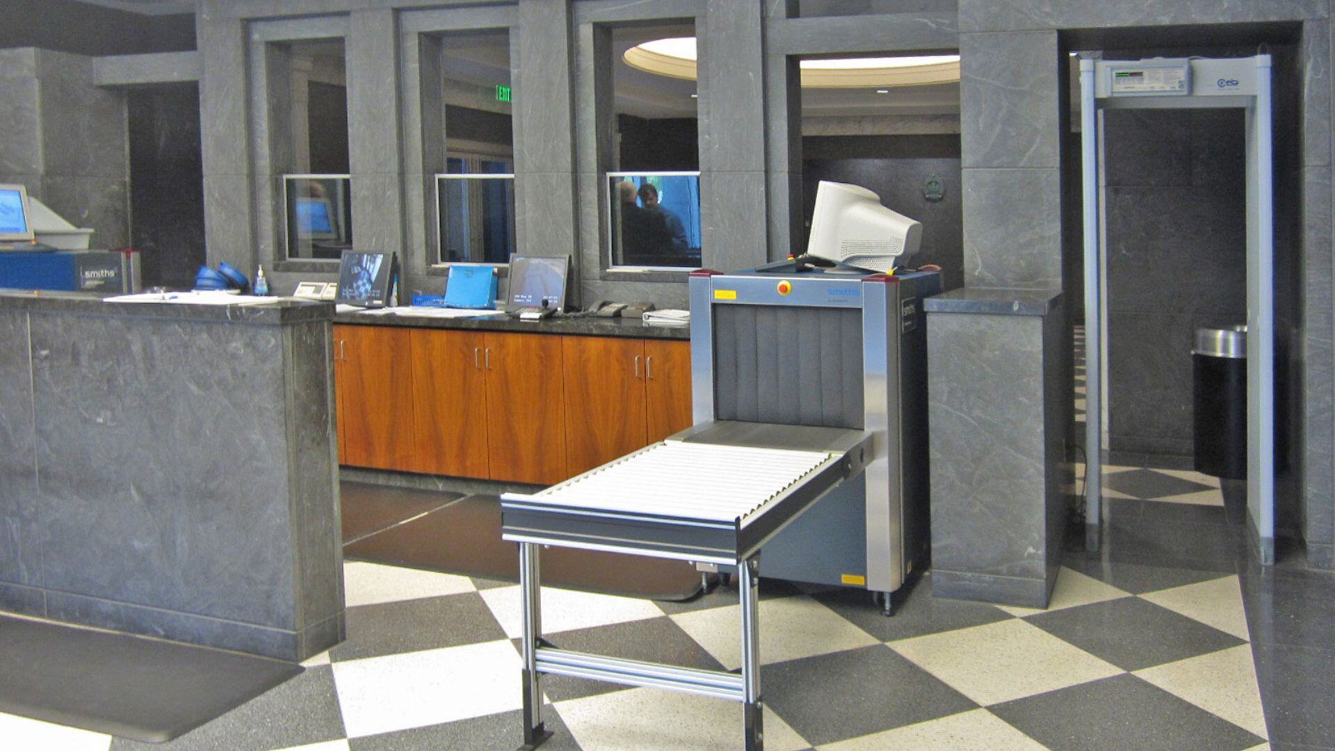 A courthouse entrance with x-ray scanner and magnetometer 