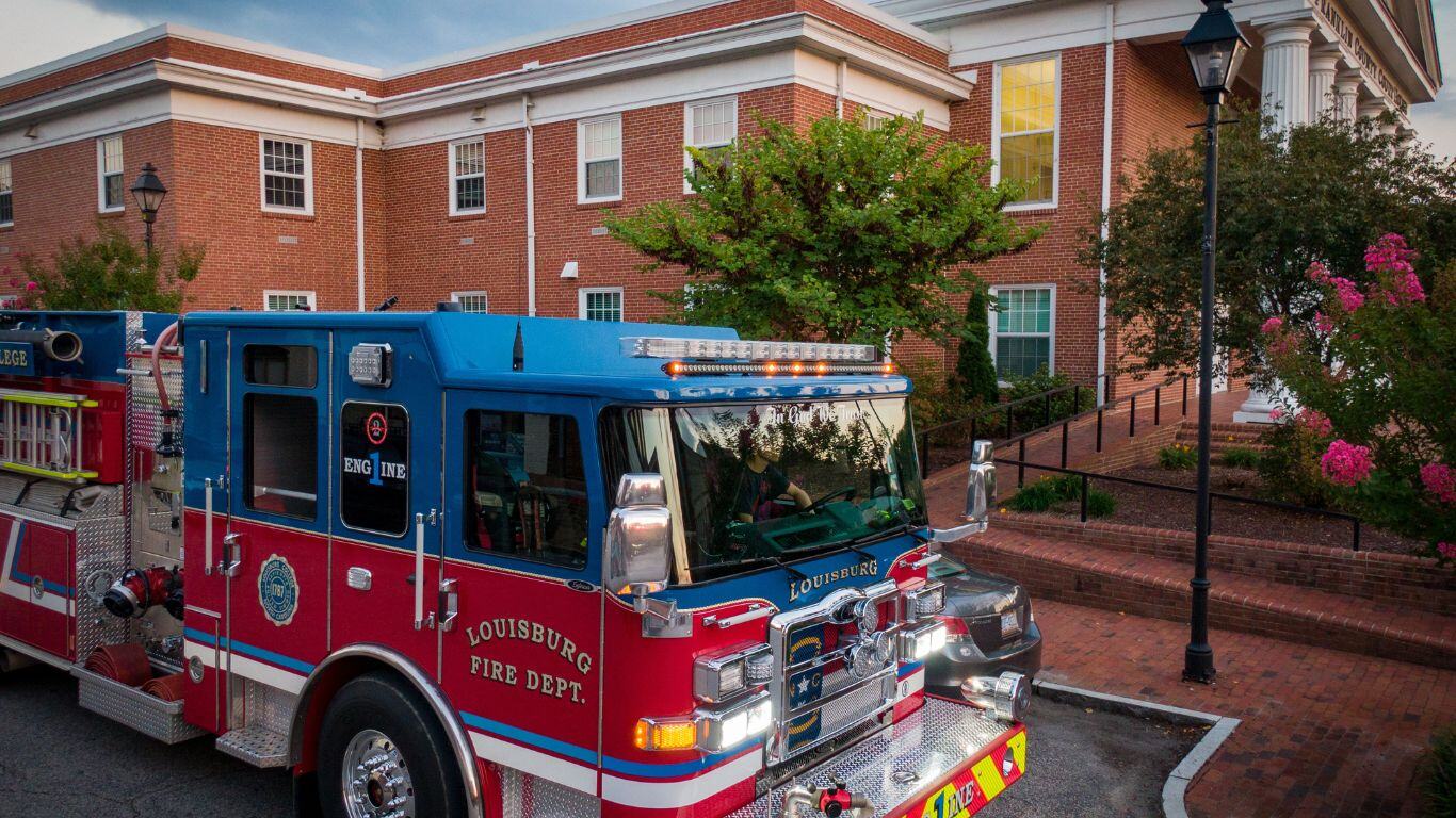 An emergency response vehicle in front of a courthouse