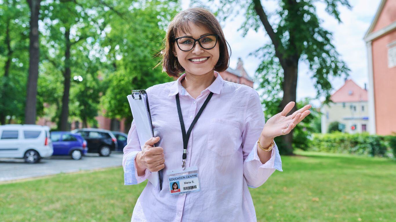 Teachers wearing a badge that can carry a mobile panic button,