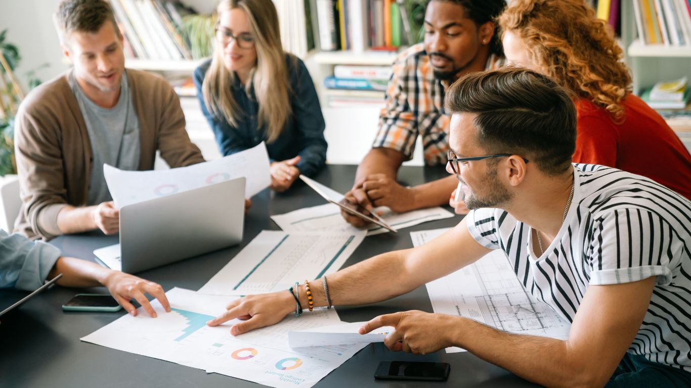People in a meeting looking at graphs